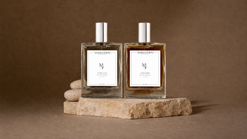 Two perfume bottles on a stone platform with a brown background